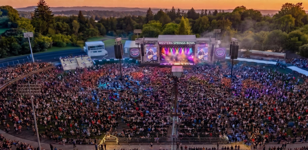 Western Springs Bowl filled with a concert crowd at dusk